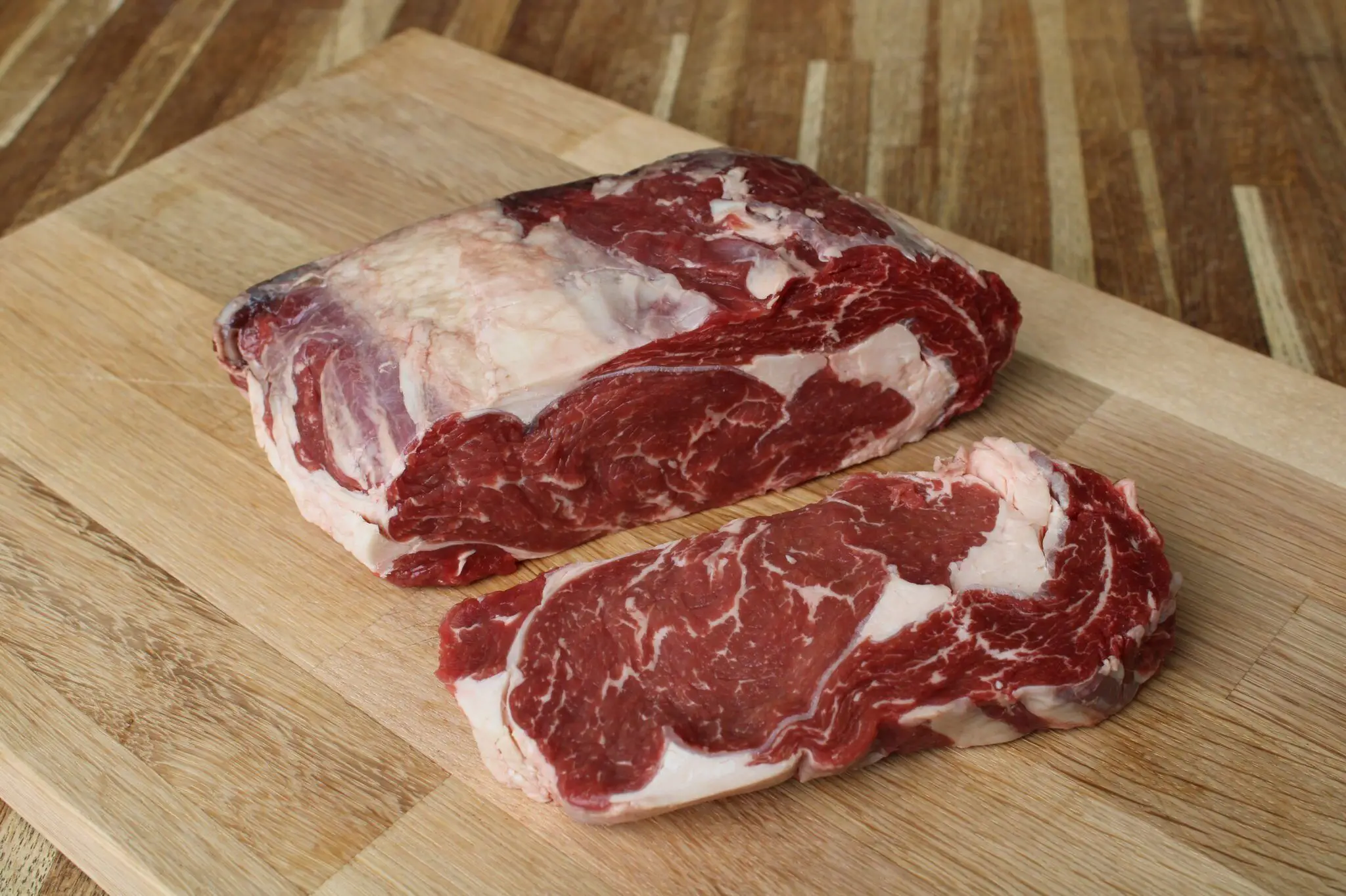 Bowhouse butchery ribeye steaks Two marbled ribeye steaks on a wooden board