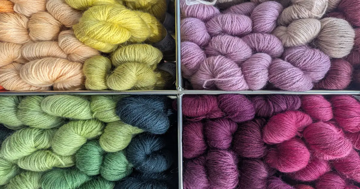 Skeins of hand-dyed yarn in yellow, pink, green and purple