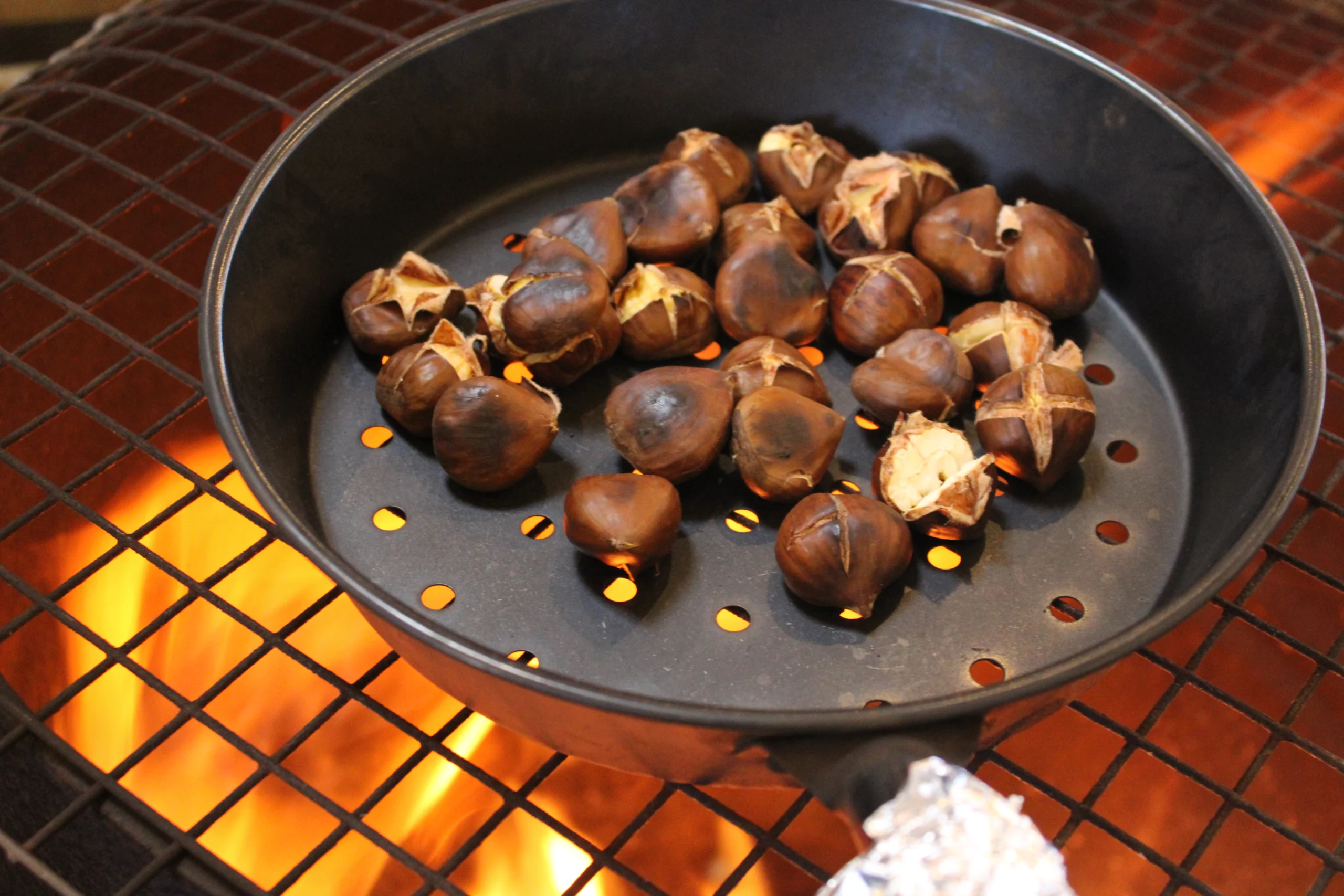 Chestnuts roasting in a pan over an open fire at the Bowhouse December market